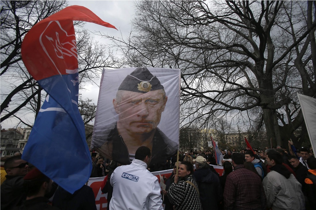 Protesters hold a picture of Russian President Vladimir Putin during a protest against NATO in downtown Belgrade, Serbia, last week, 2016. Hundreds of pro-Russian Serb nationalists have held a protest against the government's deal that forges closer ties with NATO. THE ASSOCIATED PRESS